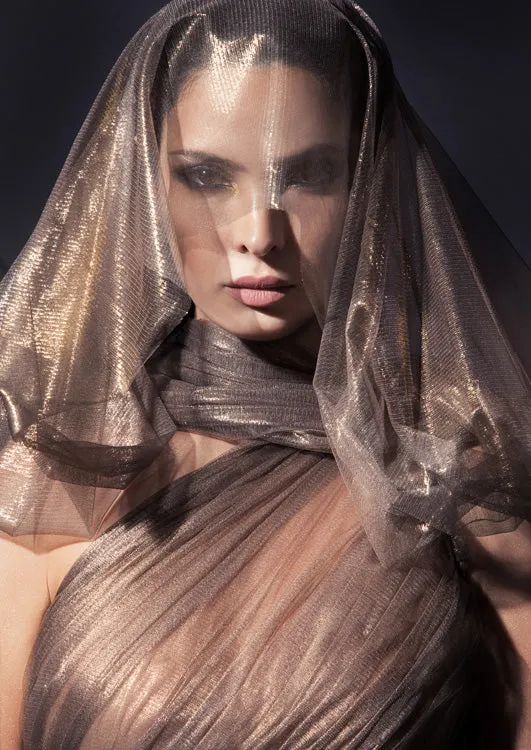 Exquisitely draped asymmetrical halter gown with caped open sleeve in fairy-spun bronze foiled silk tulle