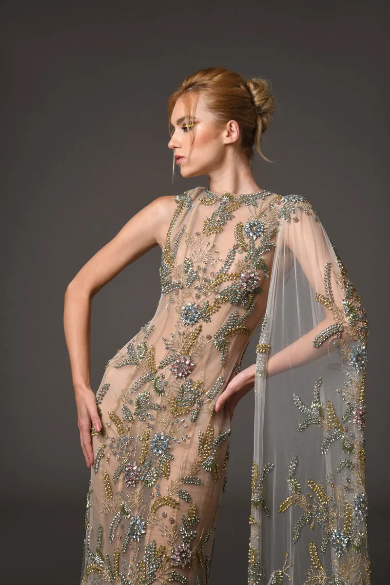 Nude silk tulle dress adorned with delicate flower embroidery and a flowing cape