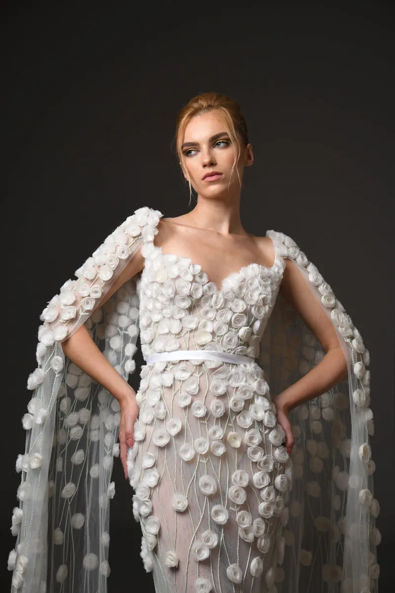 Silk tulle bridal gown embellished with hand-crafted silk organza roses featuring a sleeved cape