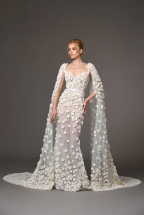 Silk tulle bridal gown embellished with hand-crafted silk organza roses featuring a sleeved cape